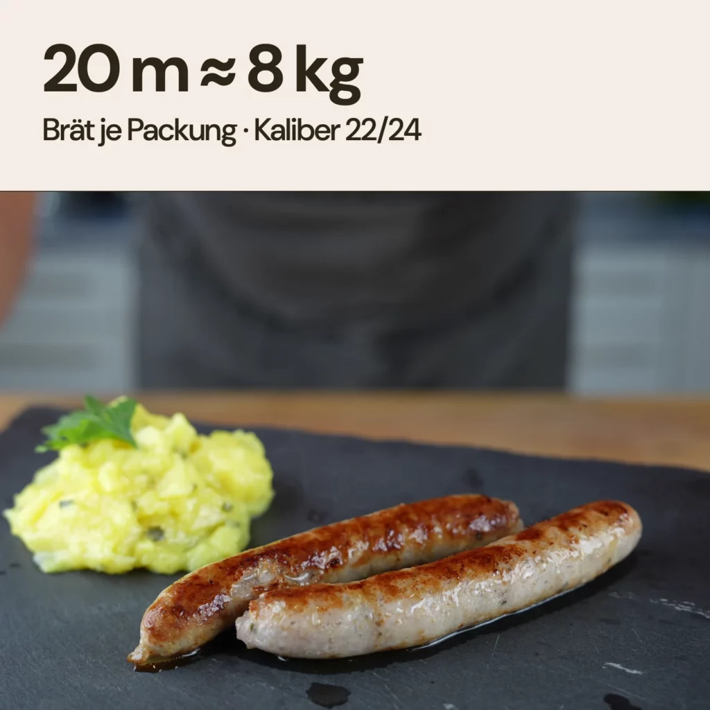 Zwei gebratene Knoblauchbratwürste im Schafsaitling Kaliber 22/24 auf Schieferplatte. 20 m Darm reichen für ca. 8 kg Brät.